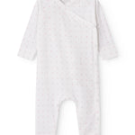 White baby all-in-one with wrap-around closure and small flowers