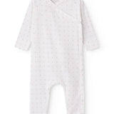 White baby all-in-one with wrap-around closure and small flowers