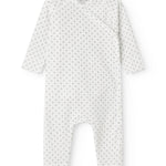White baby all-in-one with wrap-around closure and a fine pattern