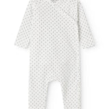 White baby all-in-one with wrap-around closure and a fine pattern