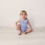 Baby in light purple bodysuit with ruffle collar