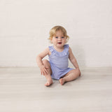 Baby in light purple bodysuit with ruffle collar