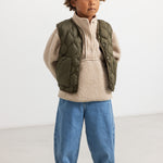 Olive green teddy parka with quilted pattern and beige fleece hood, snap buttons in front.