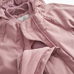 Pink flight suit with zipper and fleece/wool cuff at the wrist.