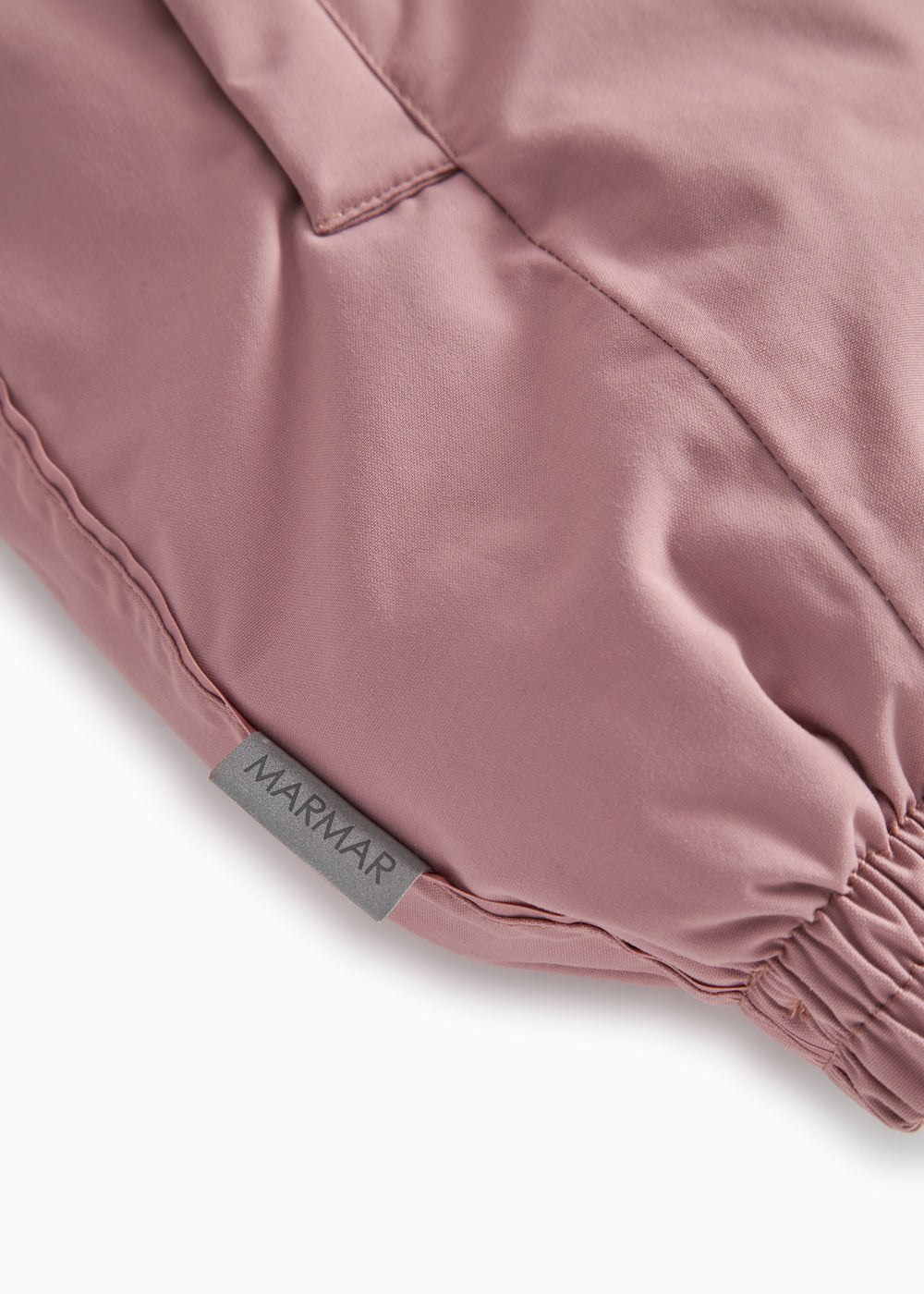 Pink jumpsuit with elastic leg edge and MARmAR label on seam.