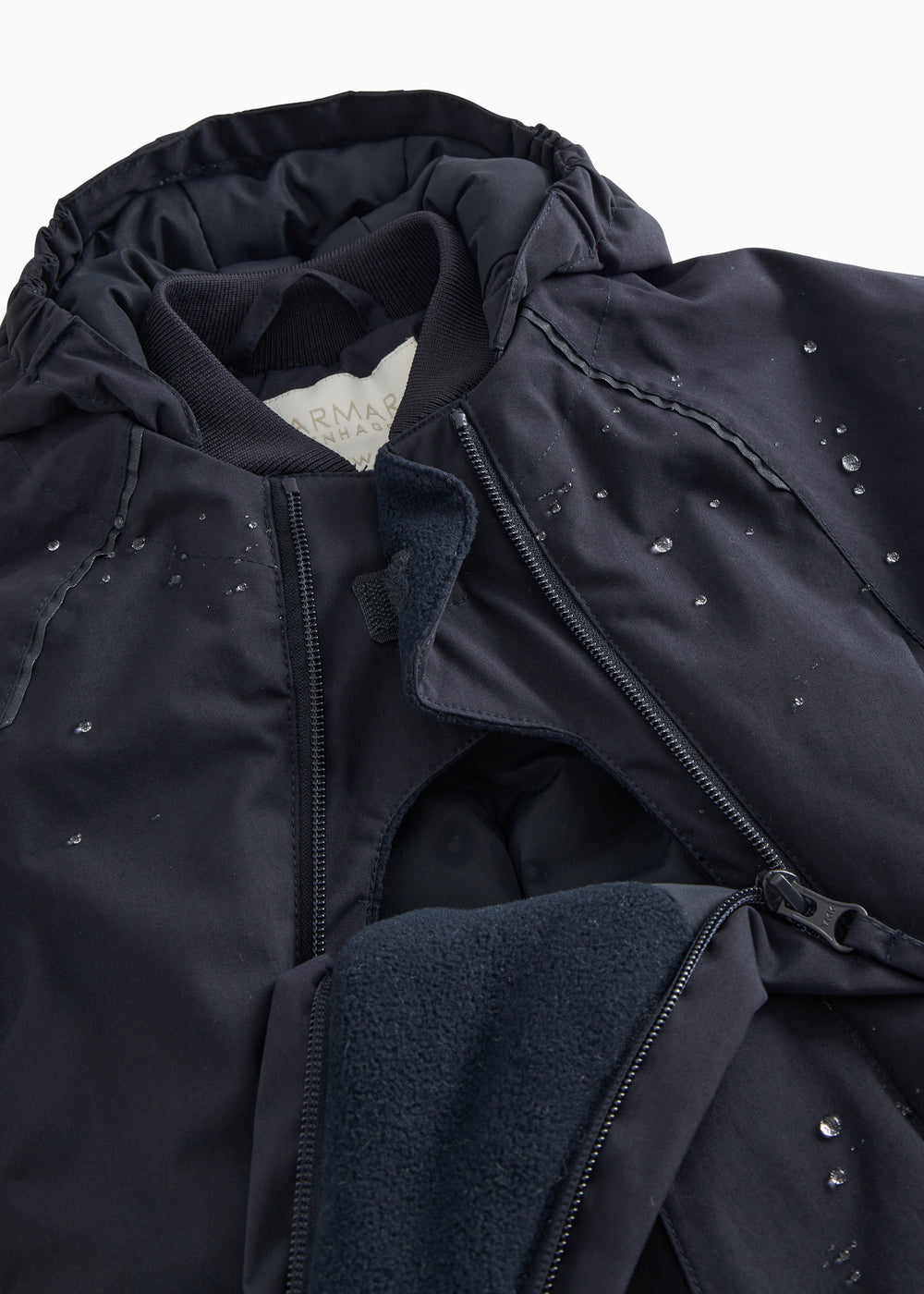 Black jumpsuit with visible zipper, fleece lining, and small reflective dots.