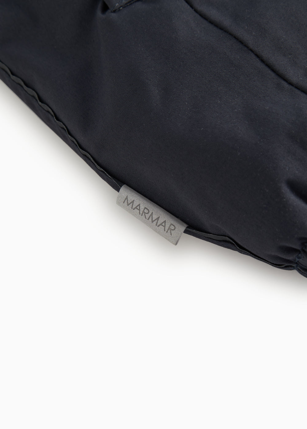 Dark flight suit pants with MARMAR label at the bottom of the leg.