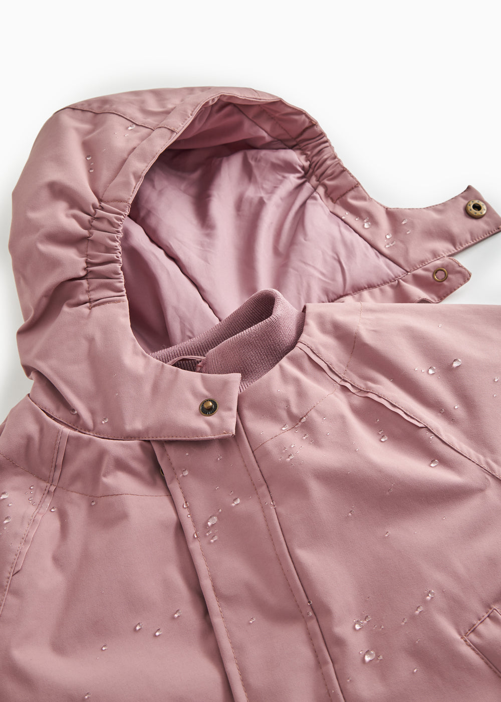 Details of winter jacket: hood, zipper and snap buttons at the collar.