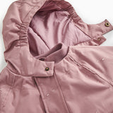 Details of winter jacket: hood, zipper and snap buttons at the collar.