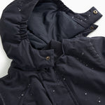 Winter jacket in dark navy with lined interior and snap buttons on the sleeves.