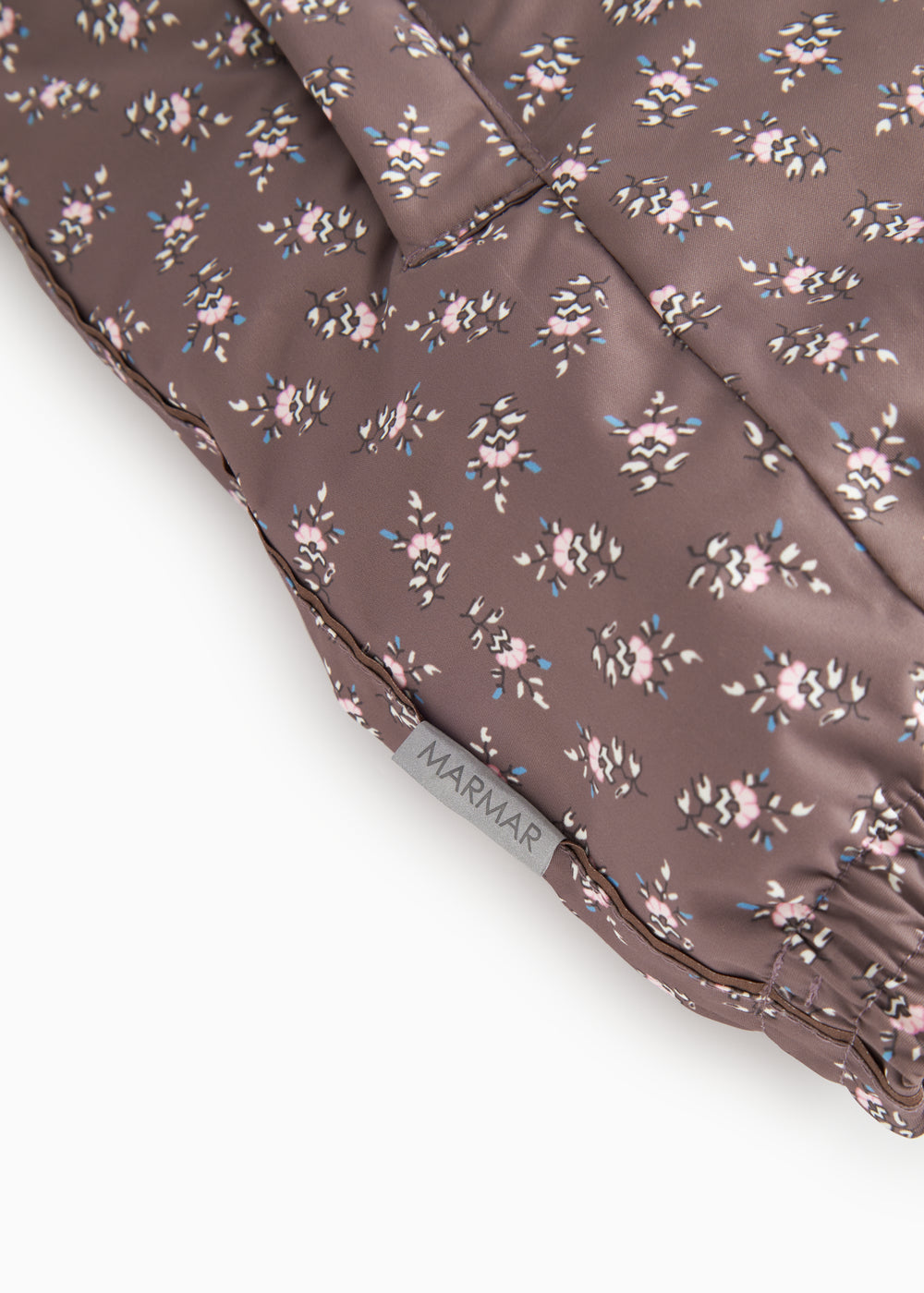 Brown floral print flight suit with visible seam at the leg edge