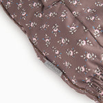 Brown floral print flight suit with visible seam at the leg edge