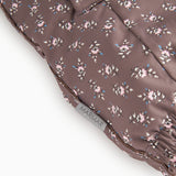 Brown floral print flight suit with visible seam at the leg edge