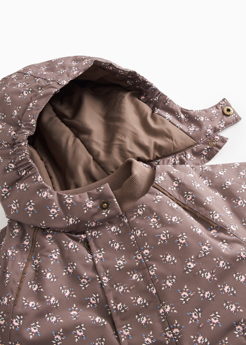 Floral patterned fleece jacket with printed button details at the collar.