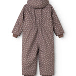 Hooded jumpsuit with small flower print; shown from behind with long legs and sleeves.