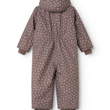 Hooded jumpsuit with small flower print; shown from behind with long legs and sleeves.