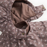Jacket with open zipper and lined interior; small floral print in dark brown.
