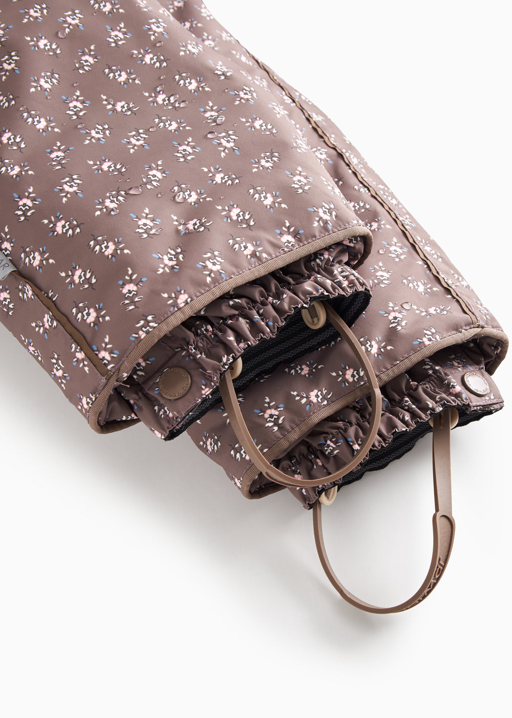 Adjustable strap suit with adjustable strap at the leg edge and small floral print.