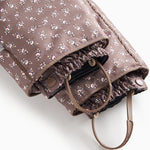 Adjustable strap suit with adjustable strap at the leg edge and small floral print.