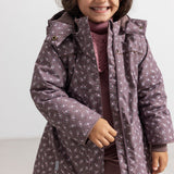 Kids winter jacket with hood, zipper and floral pattern in dark purple and pink.