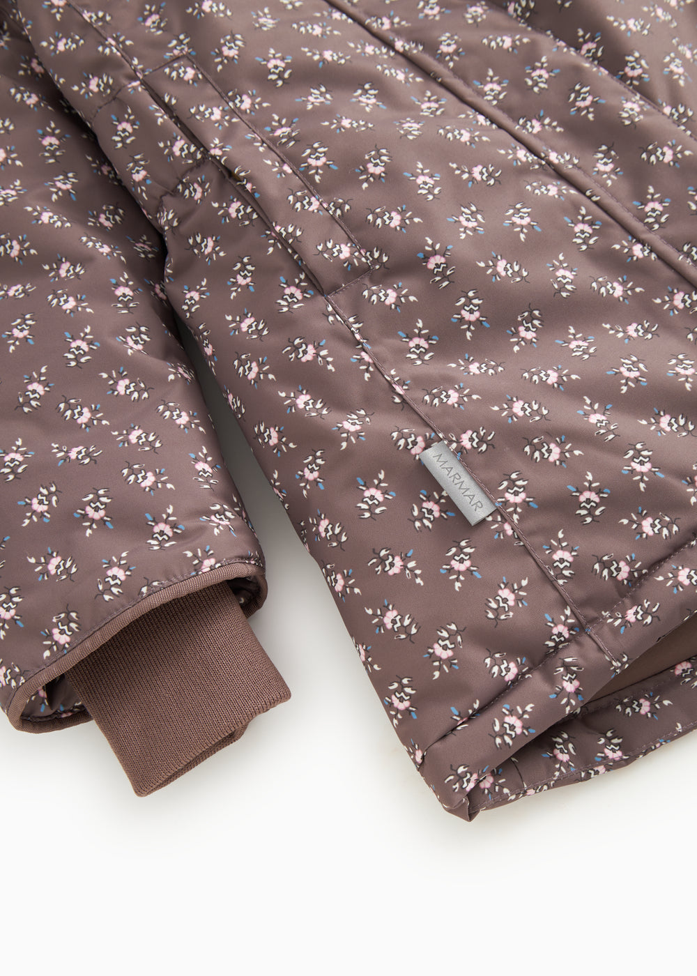 Winter jacket with hood in dark brown and small light floral print; rib cuffs