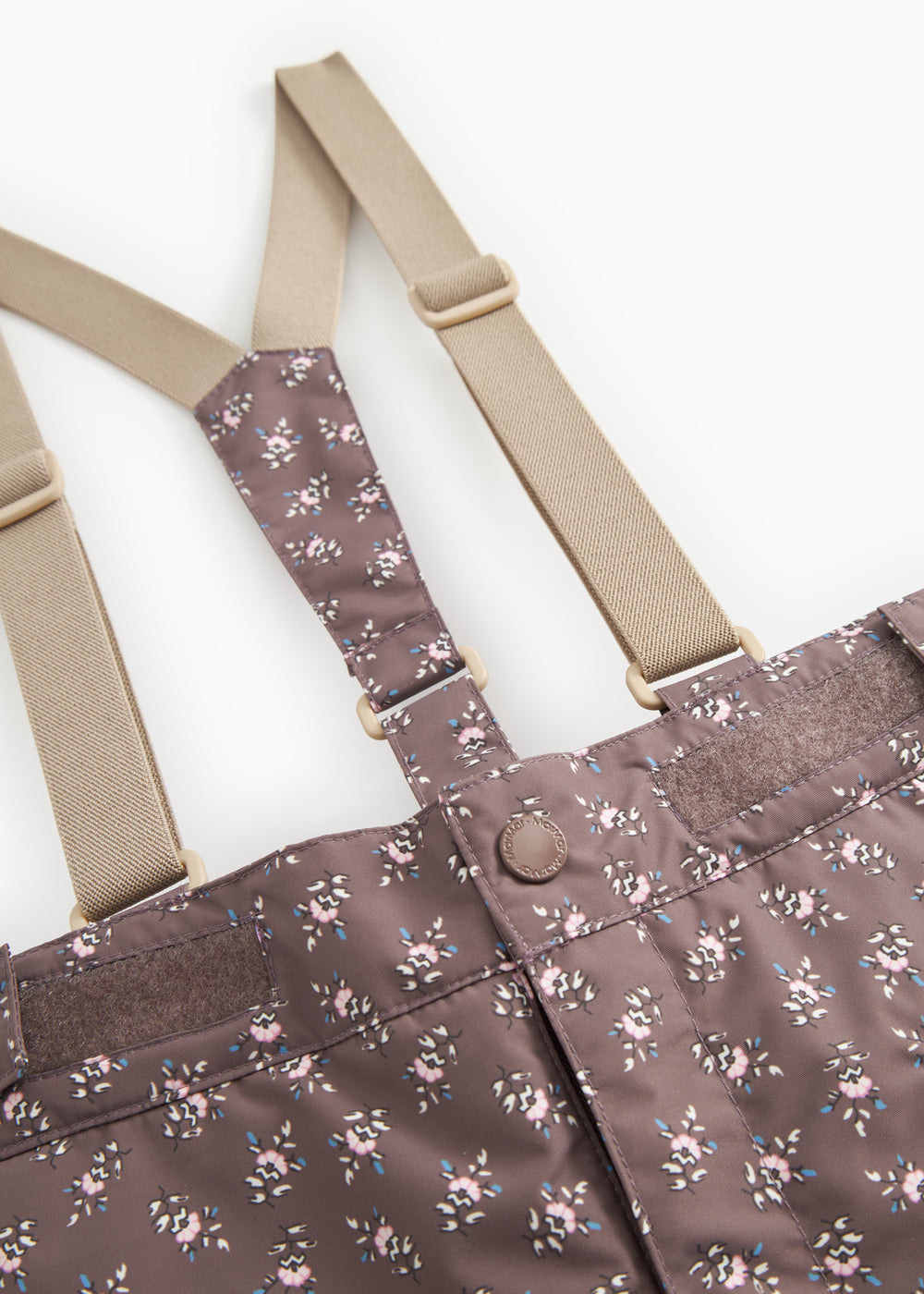 Tight-fitting trousers: suspenders with metal ring and dark brown floral print.