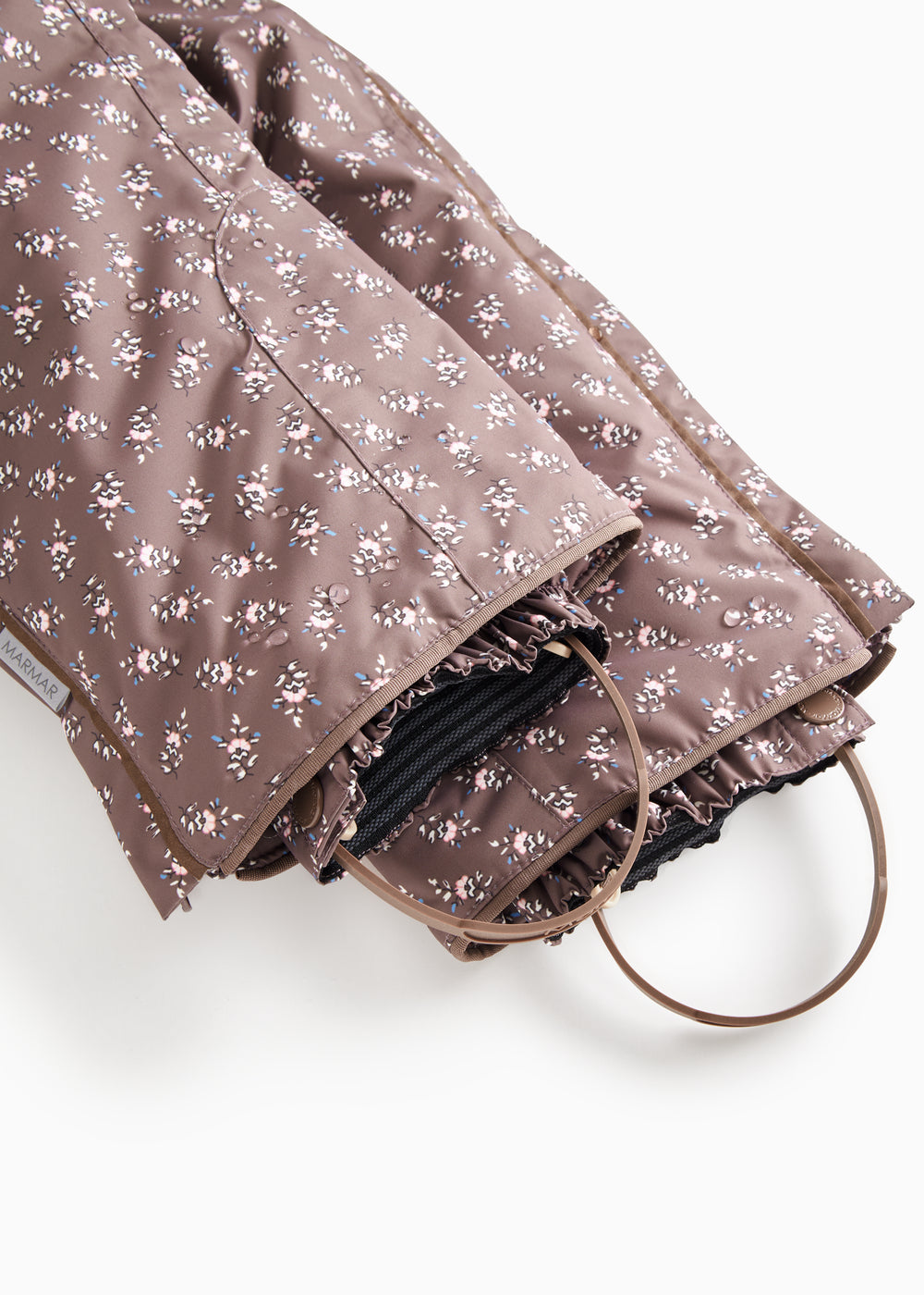 Fold-over pants with creased hem and dark brown floral print, elastic at the leg opening.