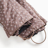 Fold-over pants with creased hem and dark brown floral print, elastic at the leg opening.