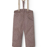 Dark brown overalls with small white flowers, adjustable straps and a central button.