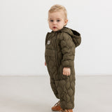 Dark green faux fur jumpsuit with hood, zipper, and quilted pattern