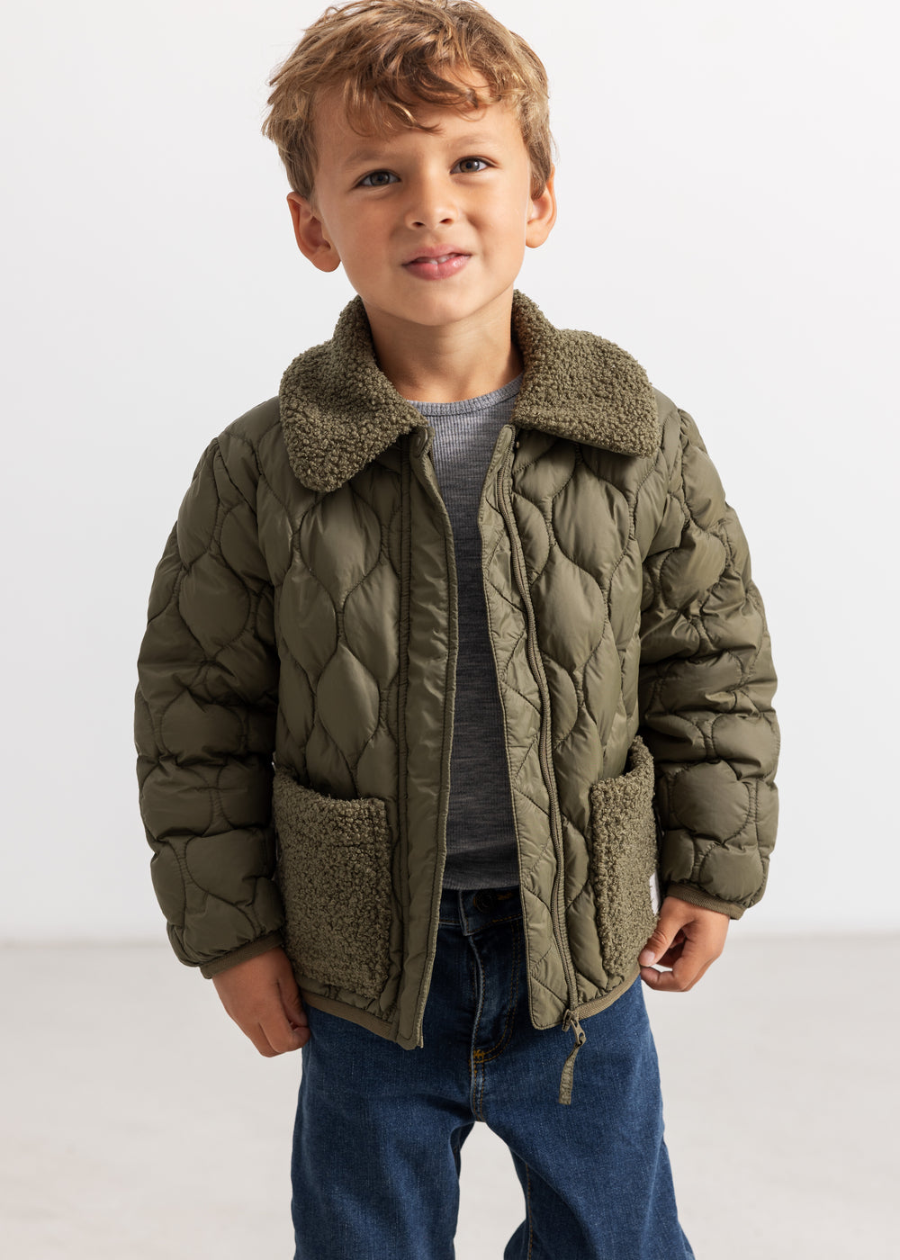 Olive quilted jacket for kids with high collar, zipper and soft fleece lining.