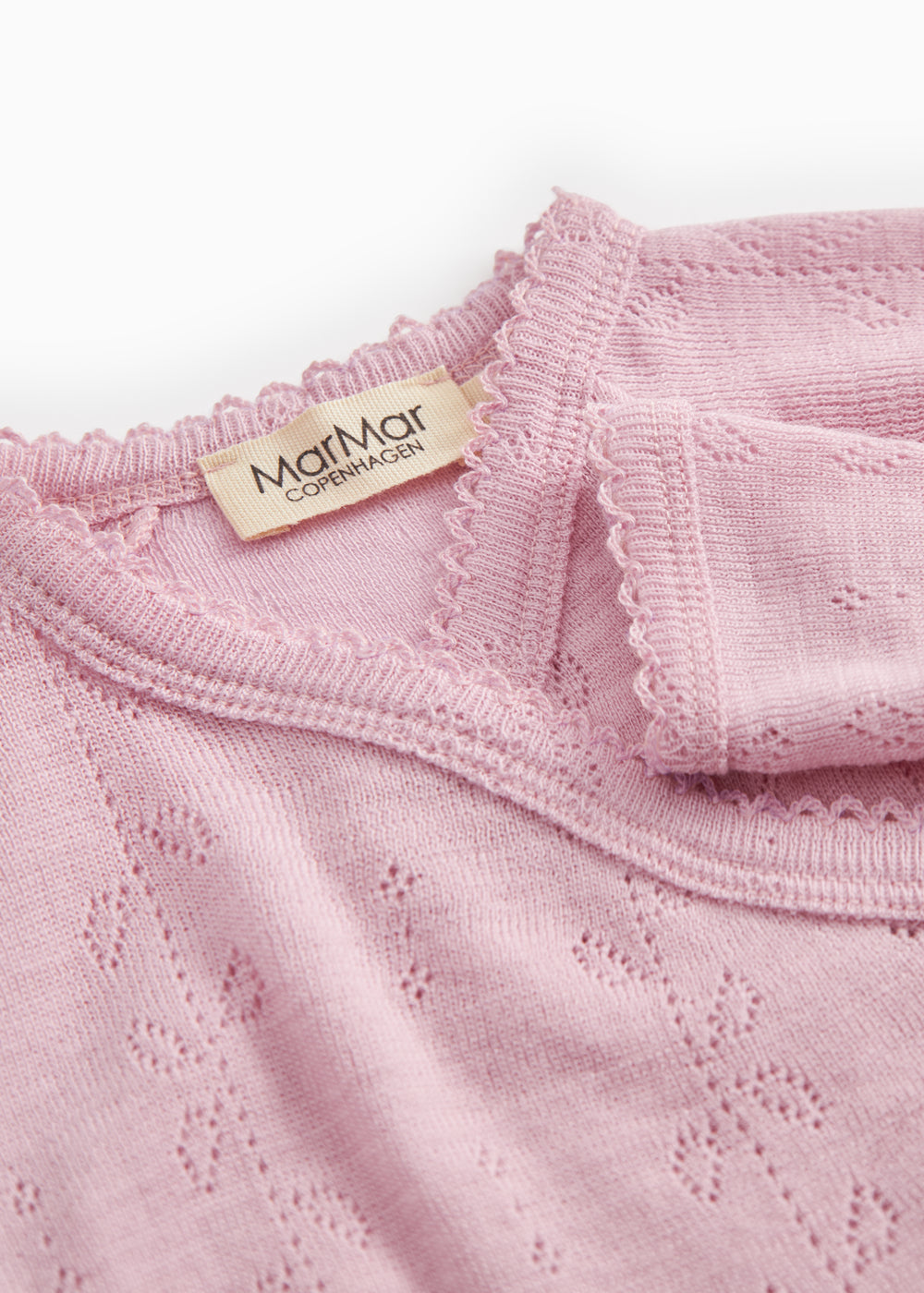 Pink bodystocking with lace pattern, ribbed collar, and visible brand label.
