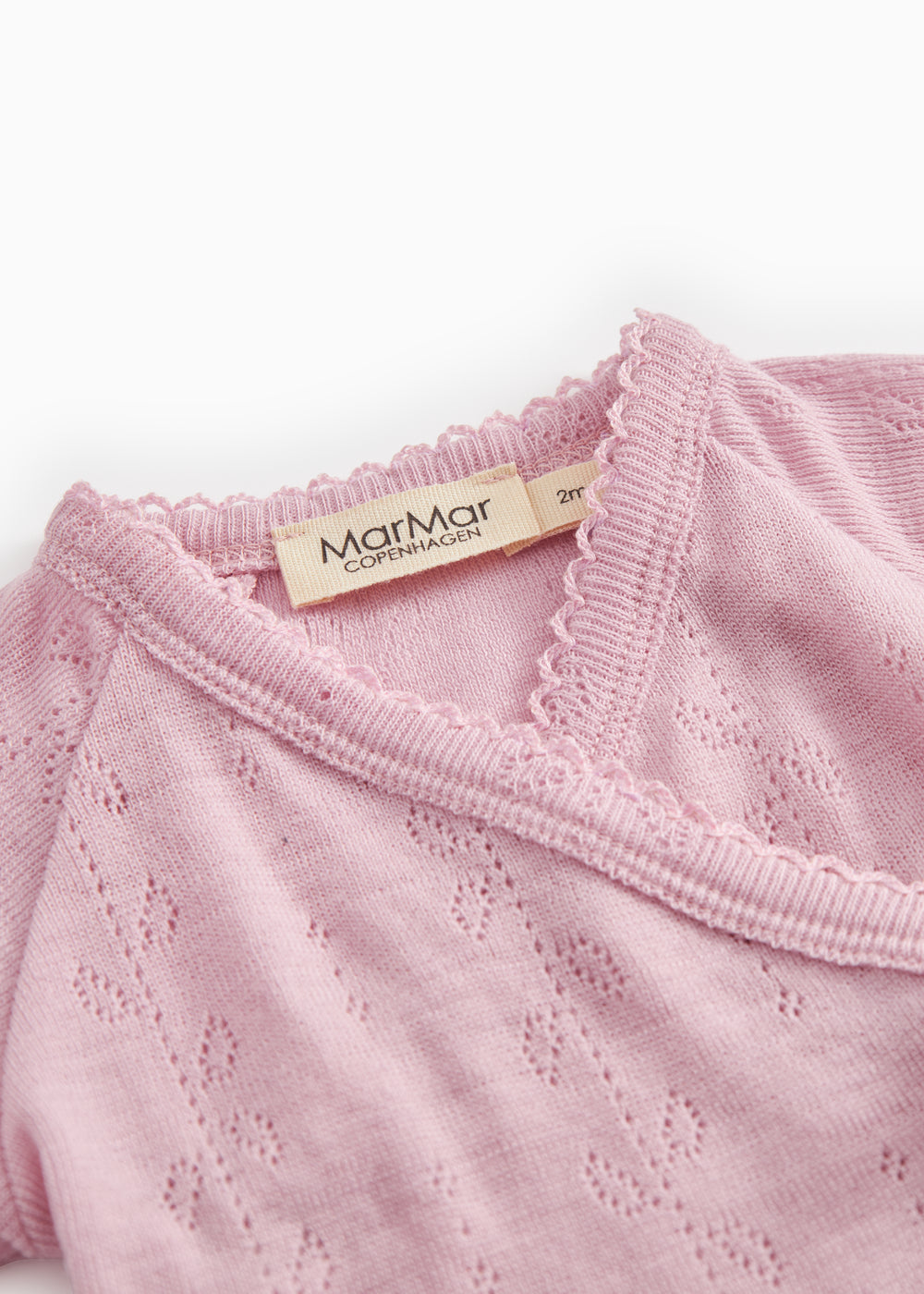 Pink blouse collar with bow and MarMar label at the neckline.