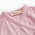Pink blouse collar with bow and MarMar label at the neckline.