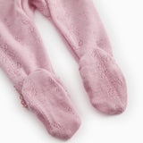 Pink jumpsuit for baby, ribbed cuffs at the feet and a finely cut pattern.