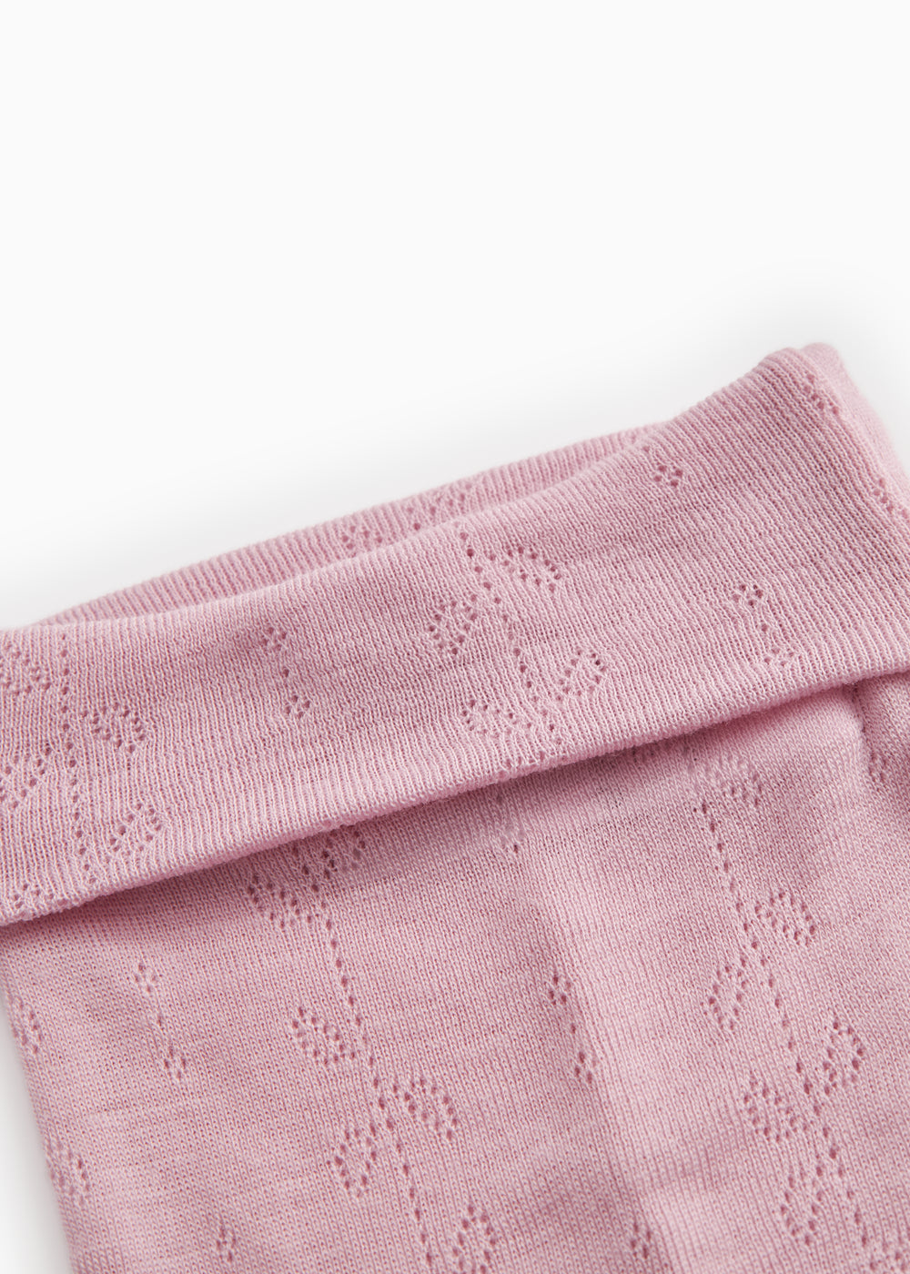 Kids' trousers in soft berry-pink with a wide ribbed edge at the top and a hollow-patterned knit.