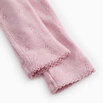 Soft berry baby pants with elastic bottom edge and floral jacquard pattern.