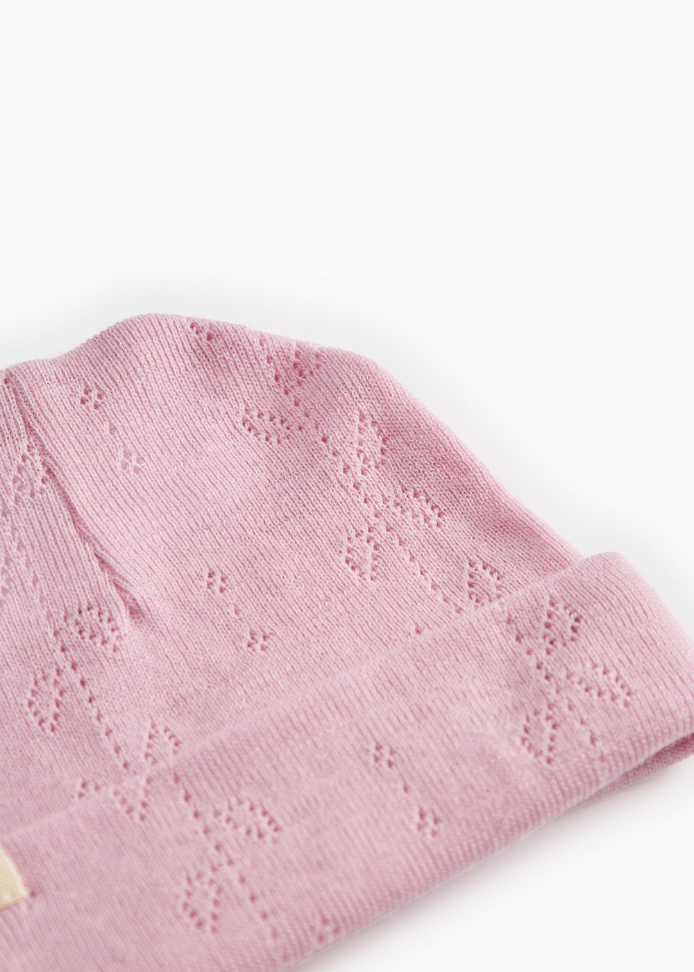 Pink striped hat with cut-out pattern and folded cuff
