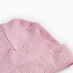 Pink striped hat with cut-out pattern and folded cuff