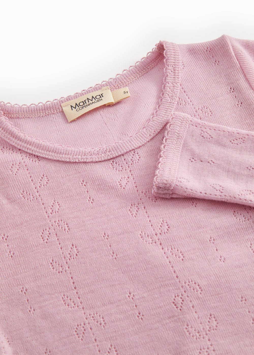 Pink t‑shirt with round neckline, eyelet pattern and visible inner label.