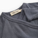 Sheer bodystocking in dark blue‑gray with ribbed collar and shoulder seams.