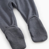 Dark gray jumpsuit with long legs and ribbed cuffs at the ankles.