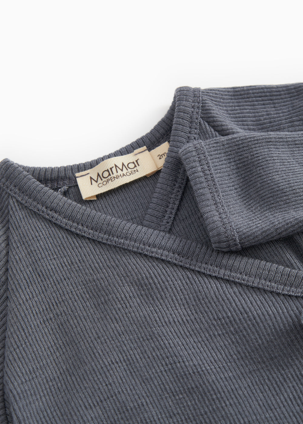 Dark gray jumpsuit with collar edge and label at the neckline.