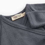 Dark gray jumpsuit with collar edge and label at the neckline.