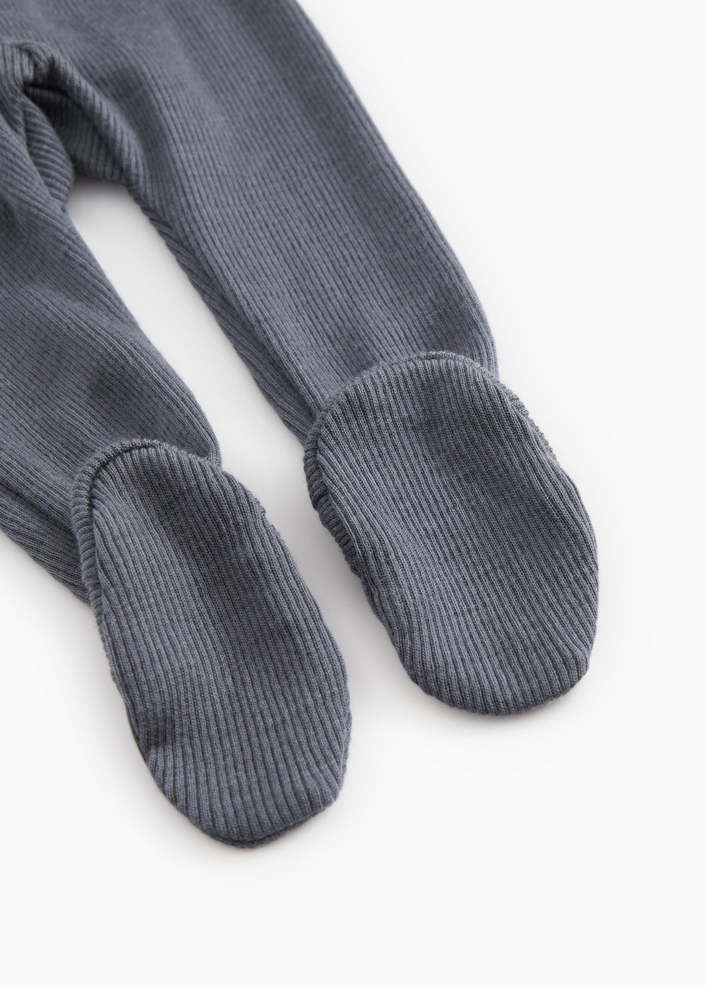 Dark blue-gray X-buk pants with ribbed cuffs at the ankles and closed toes.