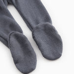 Dark blue-gray X-buk pants with ribbed cuffs at the ankles and closed toes.