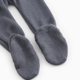 Dark blue-gray X-buk pants with ribbed cuffs at the ankles and closed toes.