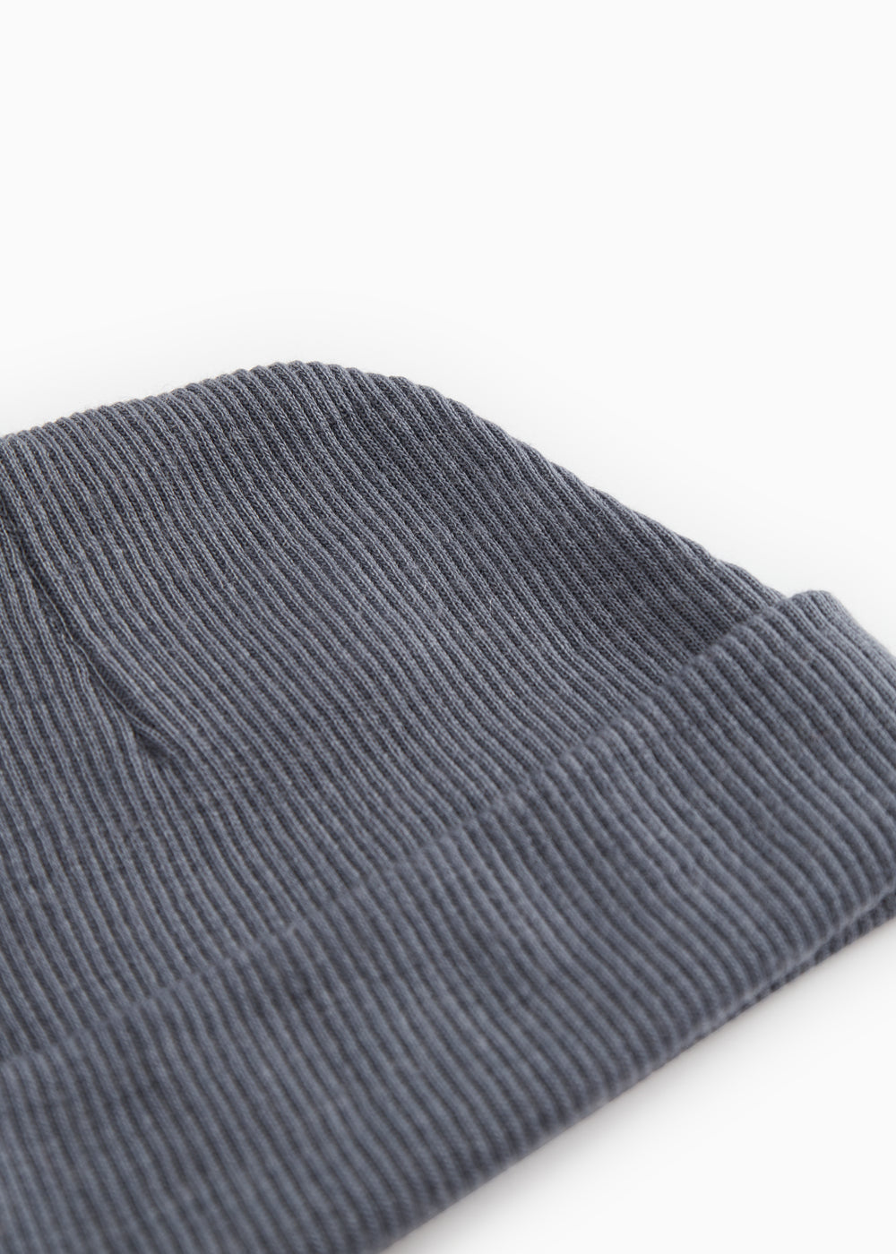 Close-up of a dark gray ribbed baby hat with a tight striped texture.