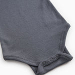 Sheer bodystocking with ribbed edge and snap buttons at the leg openings.