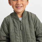 Green quilted down jacket for children with full zipper and stand-up collar.